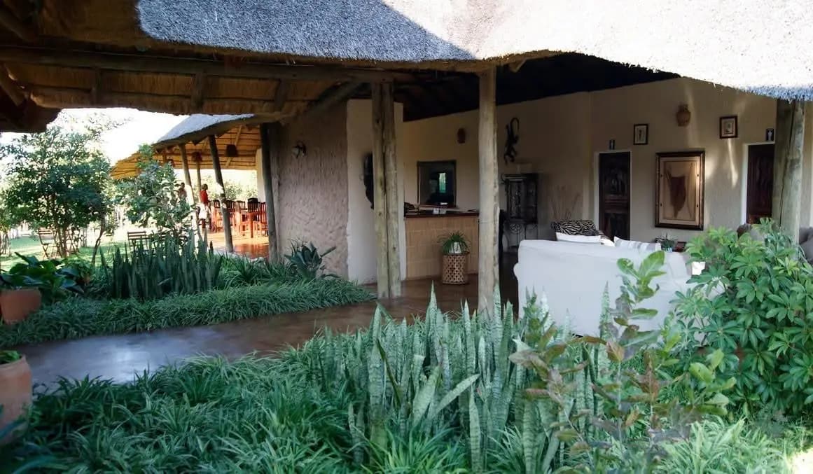 Thatched lodge building and garden