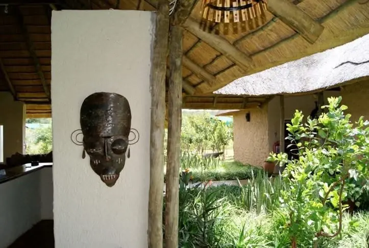 Carved mask on a verandah pillar