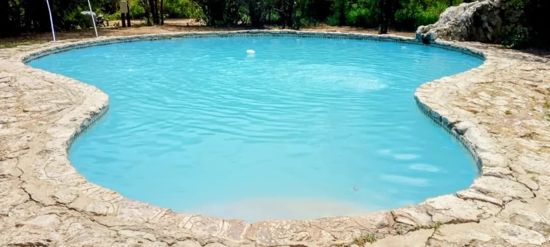 Swimming pool with a natural stone surround