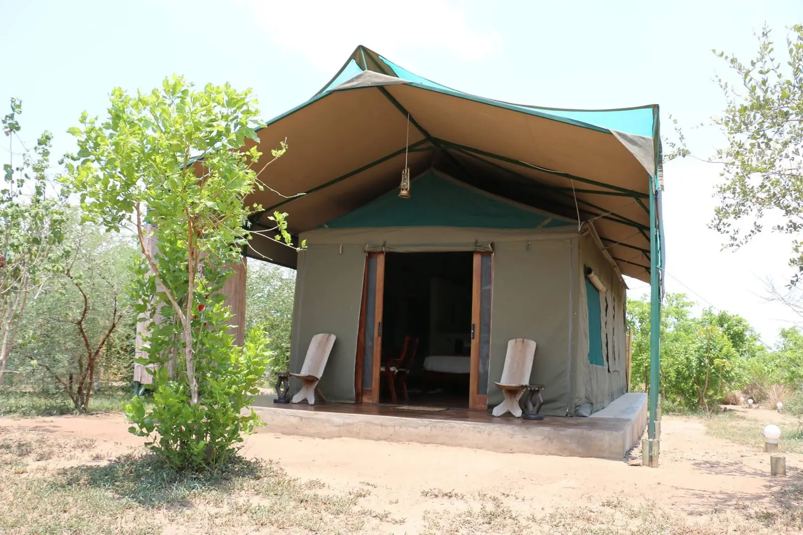 Tented chalet with carved chairs outside