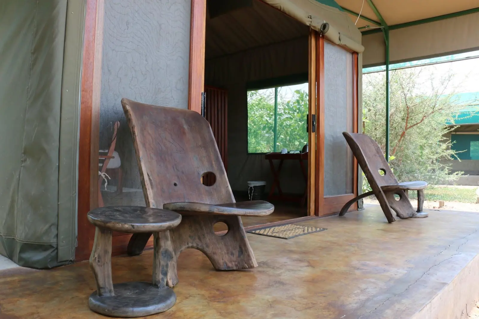 Carved chairs on a tented chalet porch