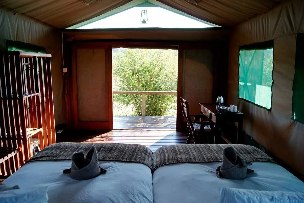 Tented chalet with towel swans on the beds