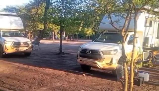 Video: Overland pick-up trucks parked in the shade on the campsite