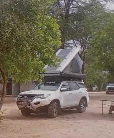 Video: White SUV with a rooftop tent parked on the campsite in the early morning