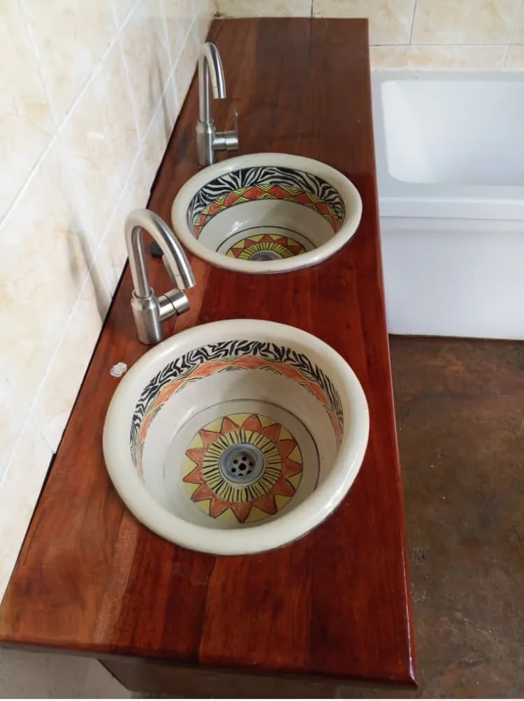 Hand-painted zebra-print basins on a wooden vanity top