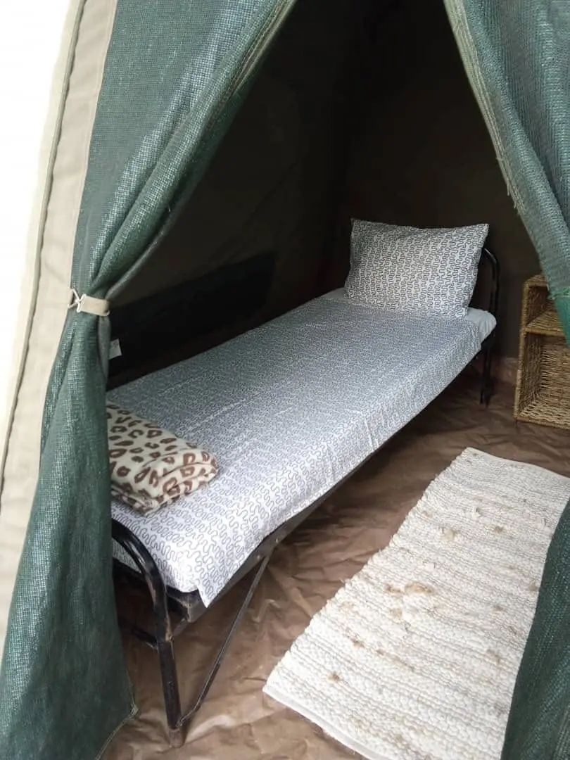 Canvas tent with a made-up camp bed