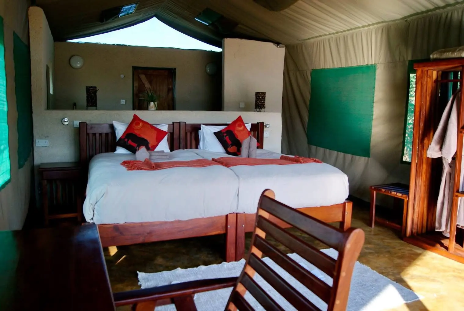 Tented chalet bedroom with red cushions
